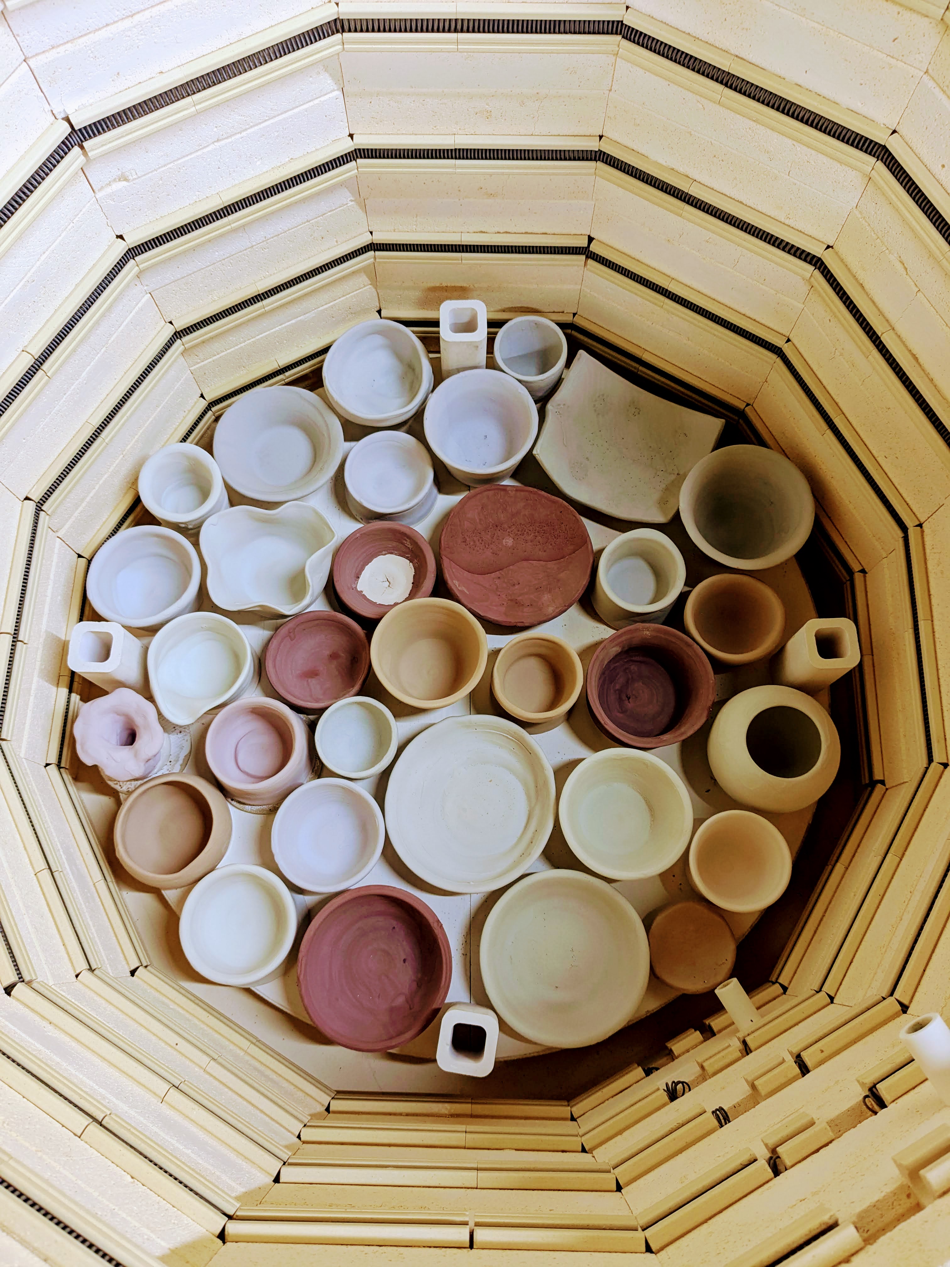 Kiln with bisqued pottery