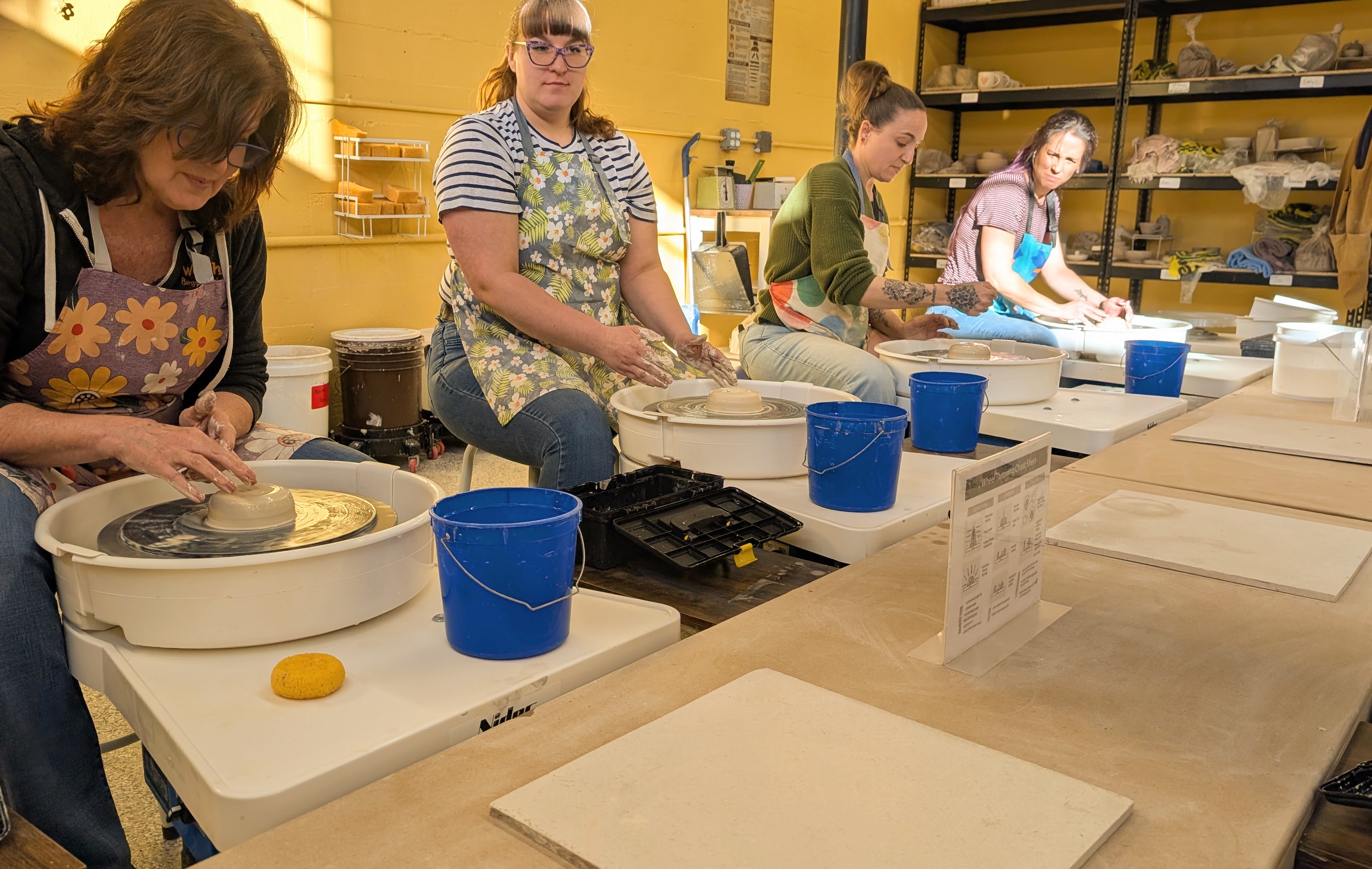 People taking a pottery wheel class