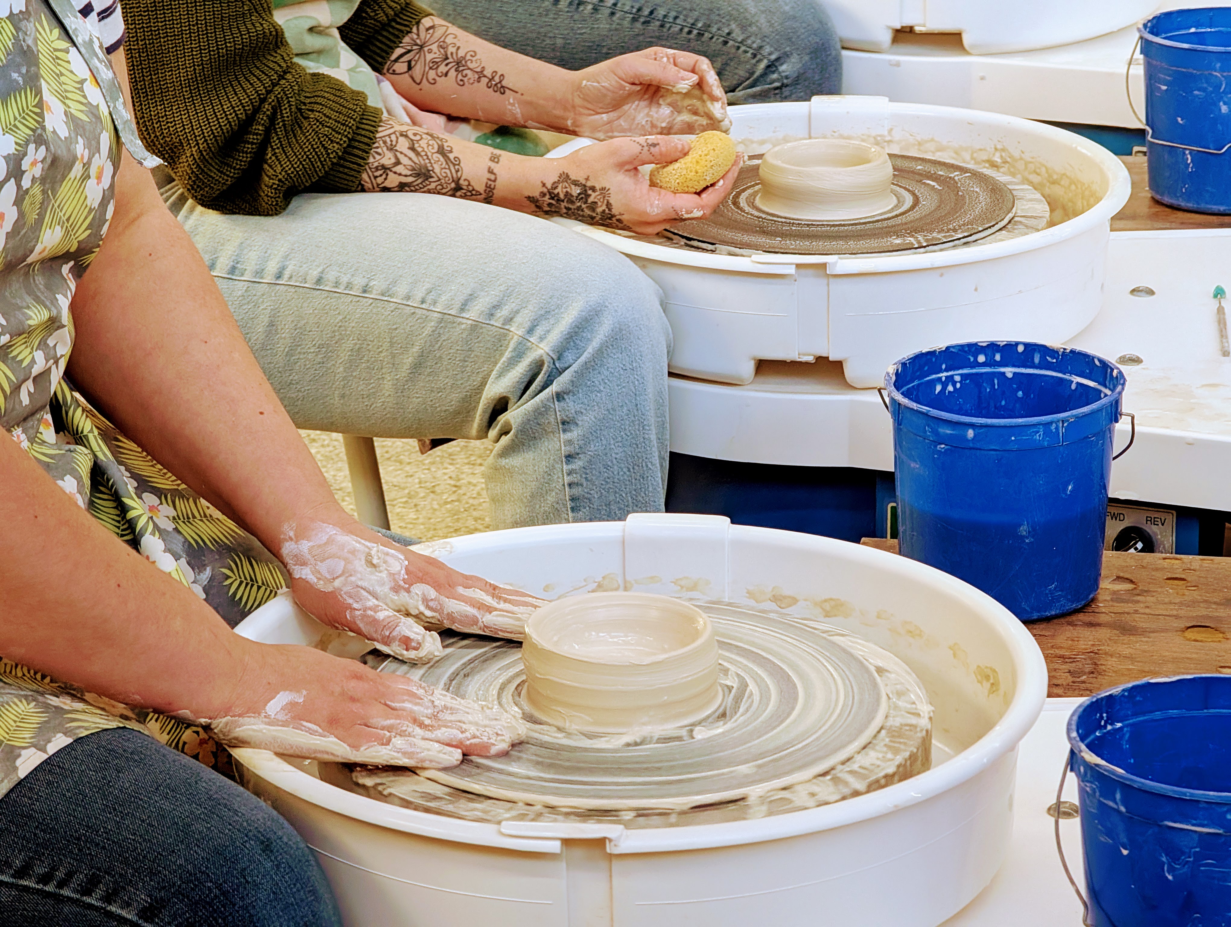 People using pottery wheels