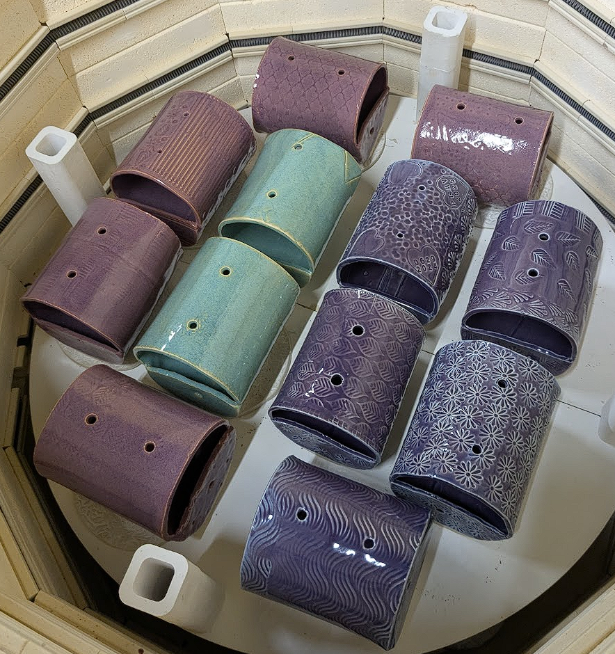 Glazed bird feeders in kiln
